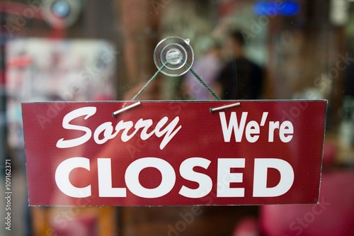 View through window of closed sign in shop photo