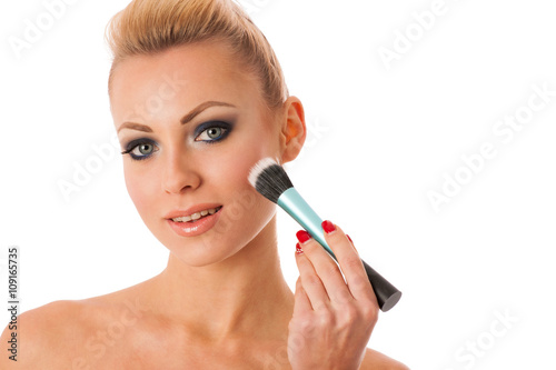 Portrait of woman holding beauty accessories, mascara, pauder br