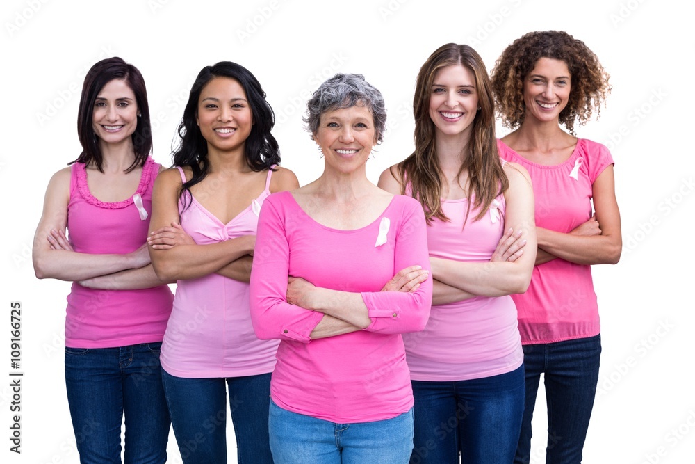 Smiling women in pink outfits posing for breast cancer awareness Smiling women in pink outfits posing for breast cancer awareness