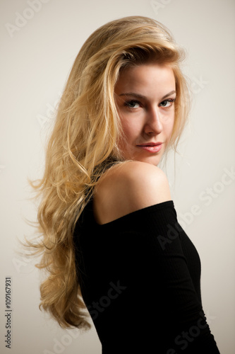 Beautiful young woman with gorgeous hairstyle posing over white