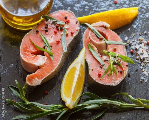 Raw fresh salmon steaks, fresh tarragon, lemon, salt and pepper