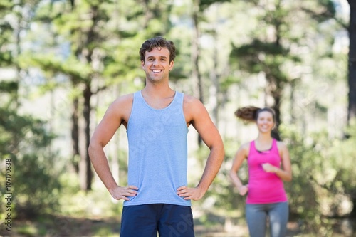 Jogger standing with woman in background