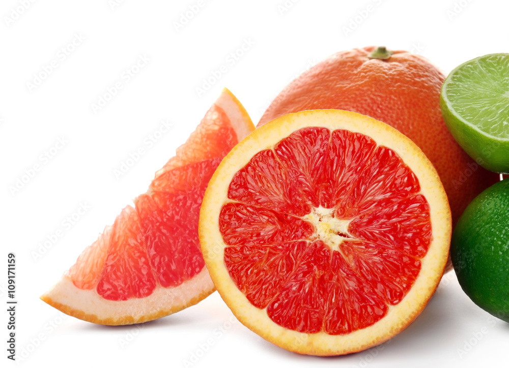 Mixed citrus fruit including grapefruits, orange and limes isolated on a white background, close up Mixed citrus fruit including grapefruits, orange and limes isolated on a white background, close up