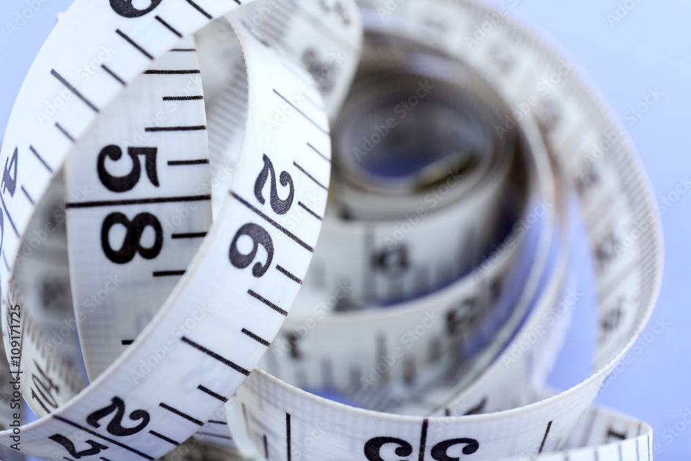 White measuring tape on a purple background White measuring tape on a purple background