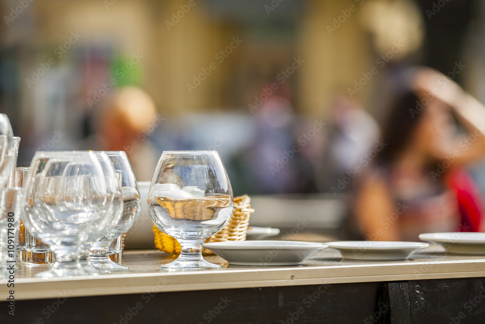 Open-air restaurant. Wine glasses.