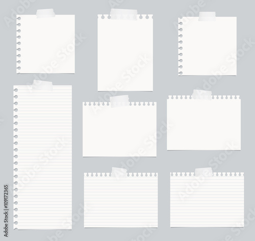 Pieces of cut out white lined notebook paper are stuck on gray background