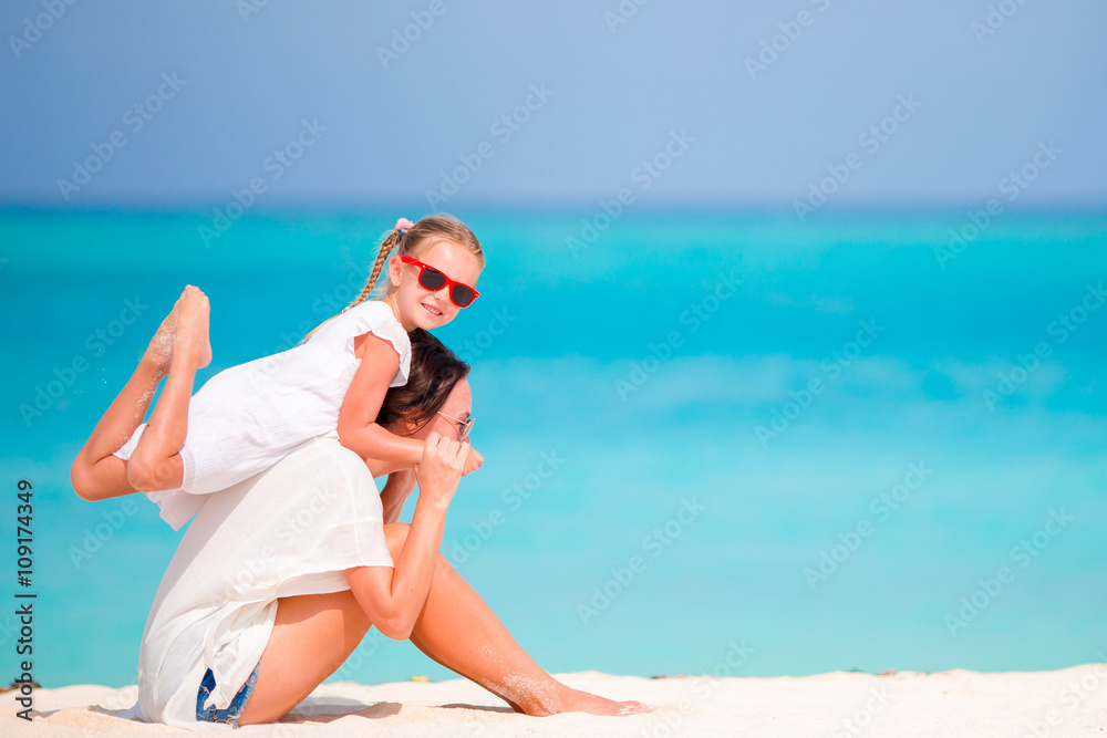 Little girl and young mother during beach vacation Little girl and young mother during beach vacation