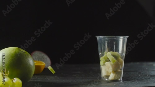 Chef Add Kiwi in Fruit Cocktail Cup with Banana  photo