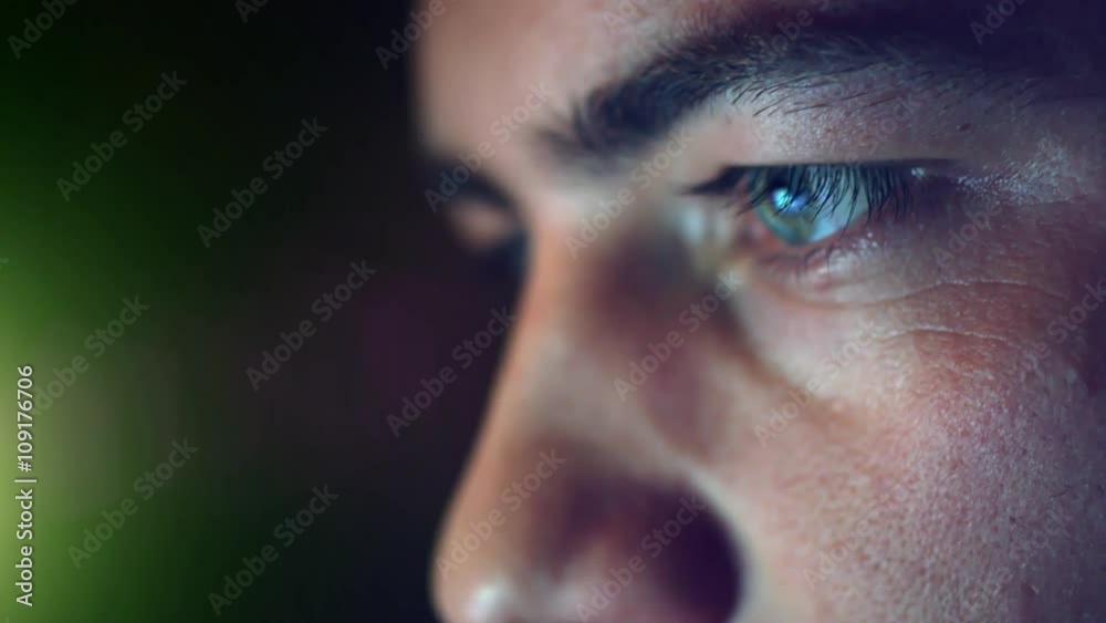 4K - UHD: Creative young Adult Man Chatting Browsing at late night  - Close Up shot on eye with Display Reflections