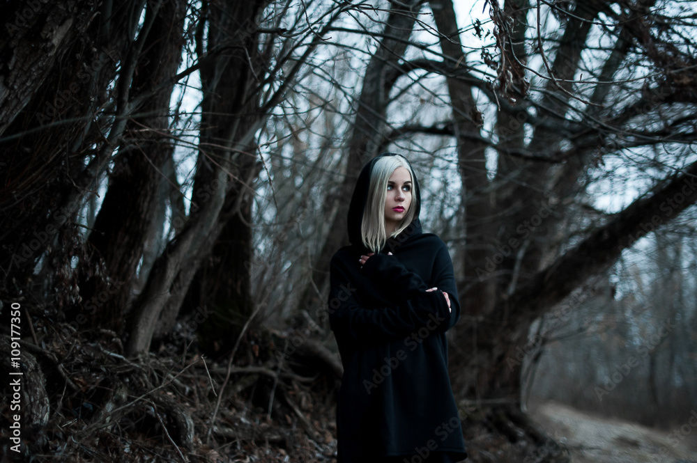 Shot of a gothic woman in a forest. Shot of a gothic woman in a forest.