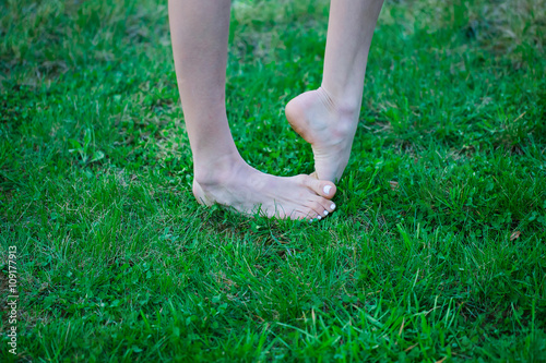 Female barefoot on grass