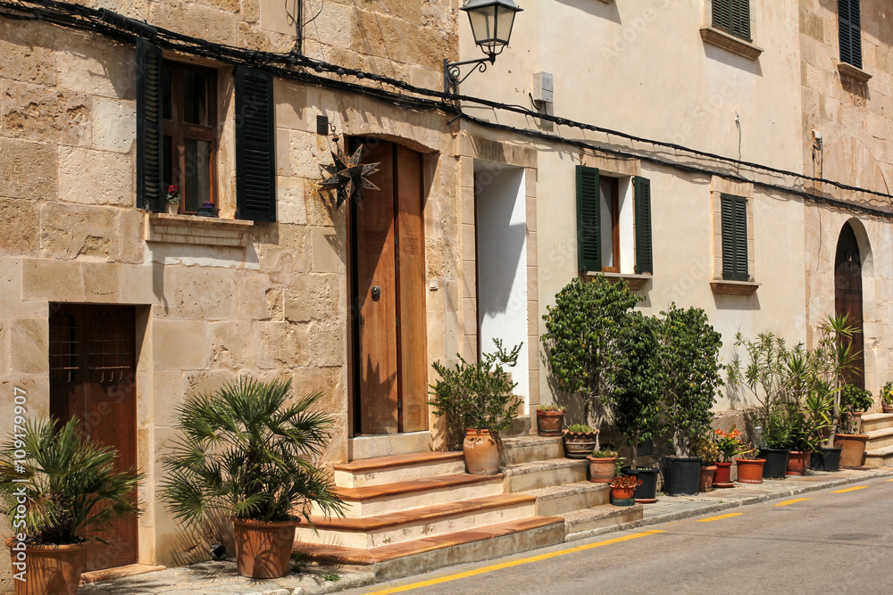 Fototapeta premium one of the charming streets decorated with flowers in Alcudia, M