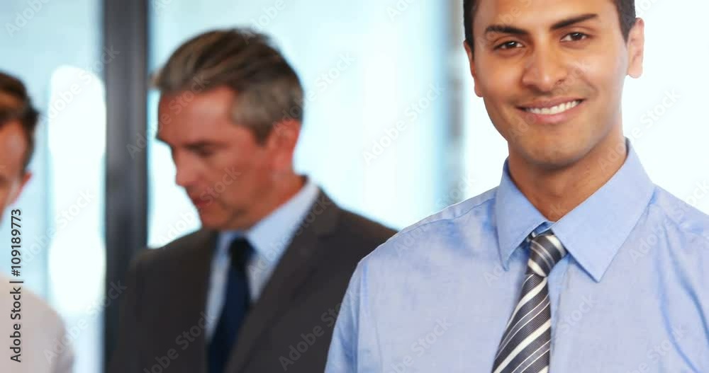 Business team standing together discussing work Business team standing together discussing work
