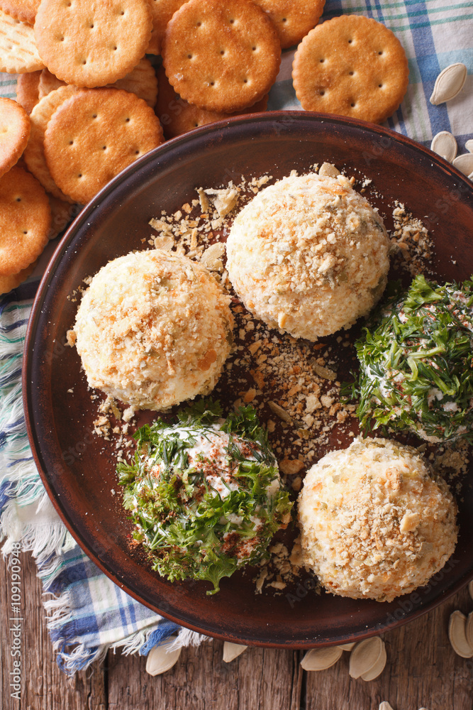 Cheese balls with crackers, herbs and seeds close-up. vertical top view
Cheese balls with crackers, herbs and seeds close-up. vertical top view