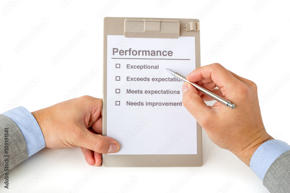 Two hands with performance checklist Two hands with performance checklist