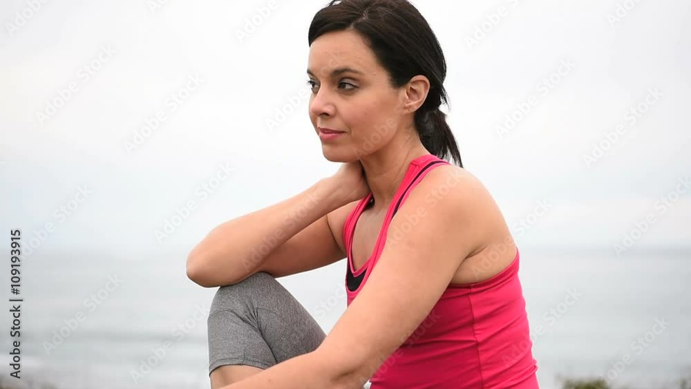 Woman in fitness outfit relaxing after exercising Woman in fitness outfit relaxing after exercising