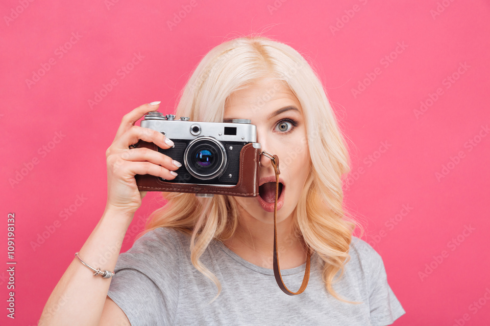 Charming woman making photo on camera - obrazy, fototapety, plakaty 