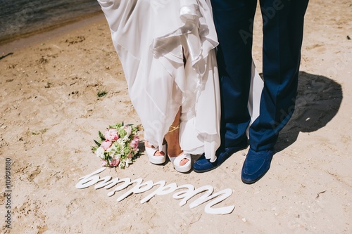 Groom and bride is walking on the bank of river