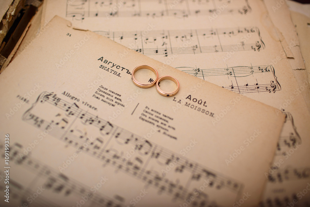 wedding rings on a musical paper