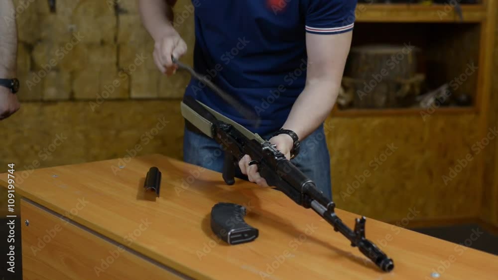 man is disassembling and assembling the rifle on the speed