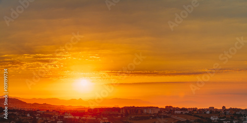Panorama of Sunset Sunrise Over Mountain And Cityscape In Spain.