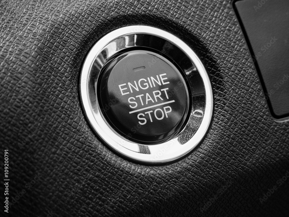 Engine car start or stop button on modern car in black tone Photos