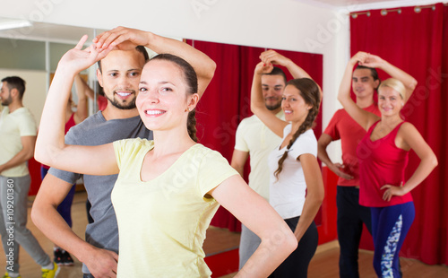 Group of people dancing salsa in studio