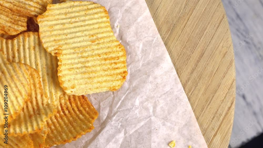 Small portion of rippled Potato Chips (seamless loopable 4K UHD footage)