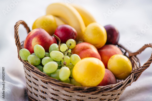 Bild auf Leinwand fruit basket on a white background
