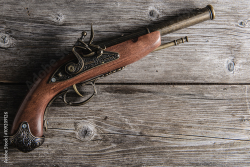 old pistol  on the wooden board photo