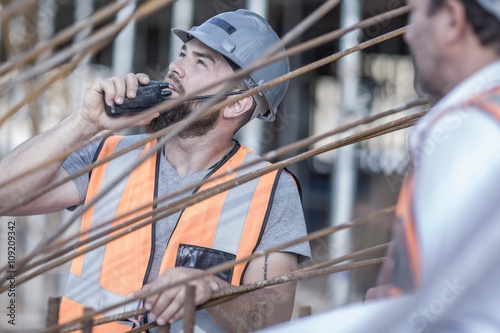 Site manager using walkie talkie on  construction site