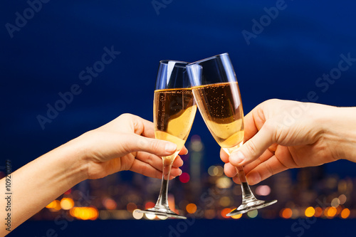 Obraz na plátně Man and woman hands with champagne glasses