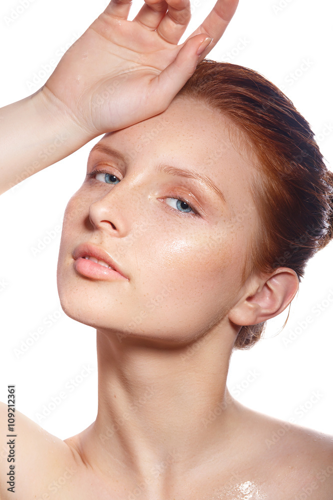 Beautiful Spa Woman Touching her chin. Youth and Skin Care Concept. Beautiful girl after a shower with wet hair and clean skin. Natural beauty. Sensual and Fresh