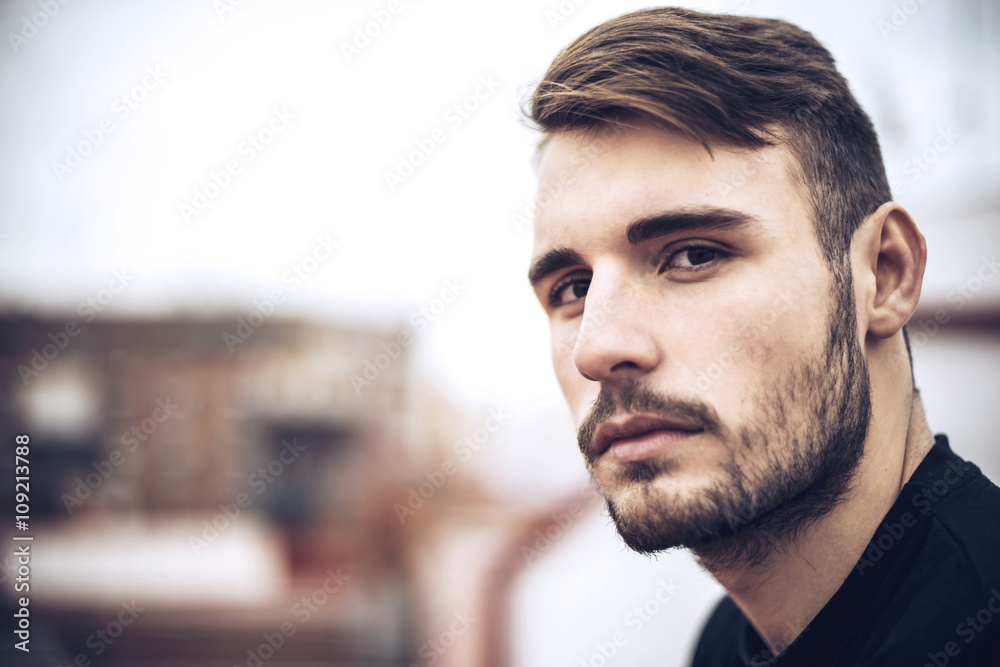 Handsome caucasian young man in casual clothes in urban environm