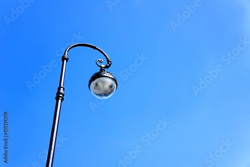 street lamppost against the blue sky