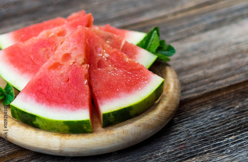 Slices of watermelon on wooden background