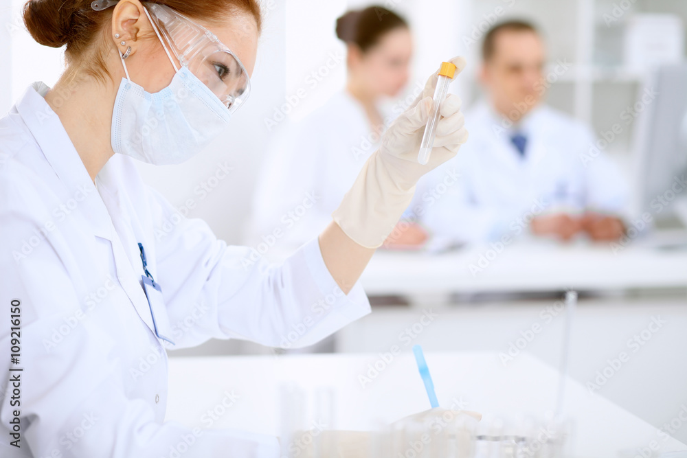 Scientific research team with clear solution in laboratory Scientific research team with clear solution in laboratory