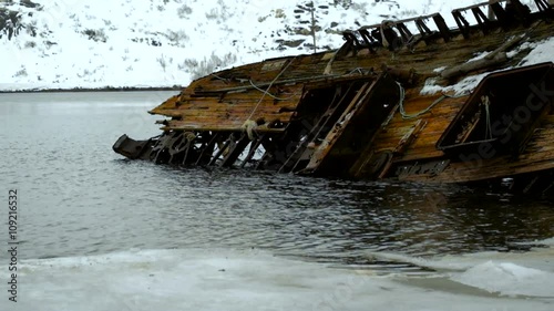 The old ship lies in the sea photo