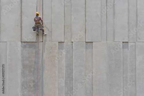 Construction worker and grey cement wall