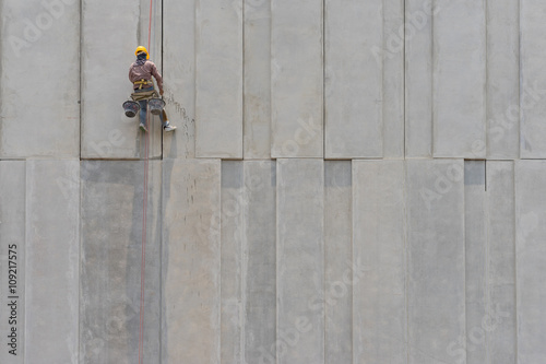 Construction worker and grey cement wall