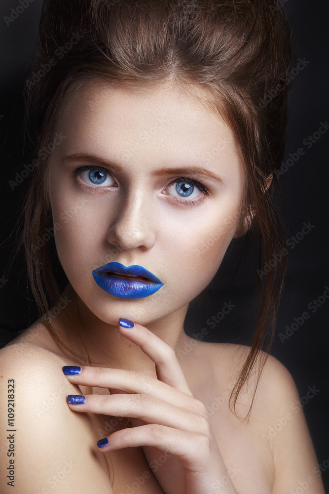 portrait of a girl with a blue lips.Beautiful young woman with creative make-up, beauty portrait. Fashion and beauty portrait of a girl with a blue lips.Beautiful young woman with creative make-up, beauty portrait. Fashion and beauty