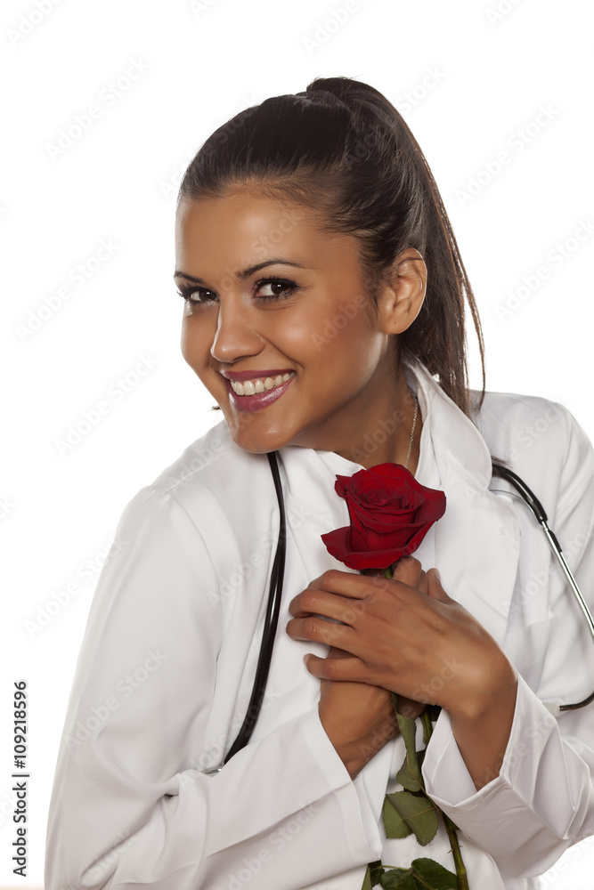 happy young woman doctor with a rose in her arms happy young woman doctor with a rose in her arms