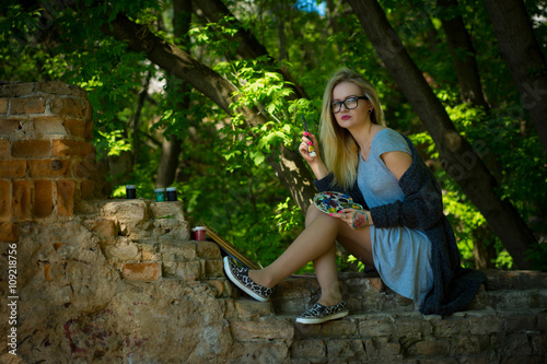 Young pretty woman paintig outdoor photo