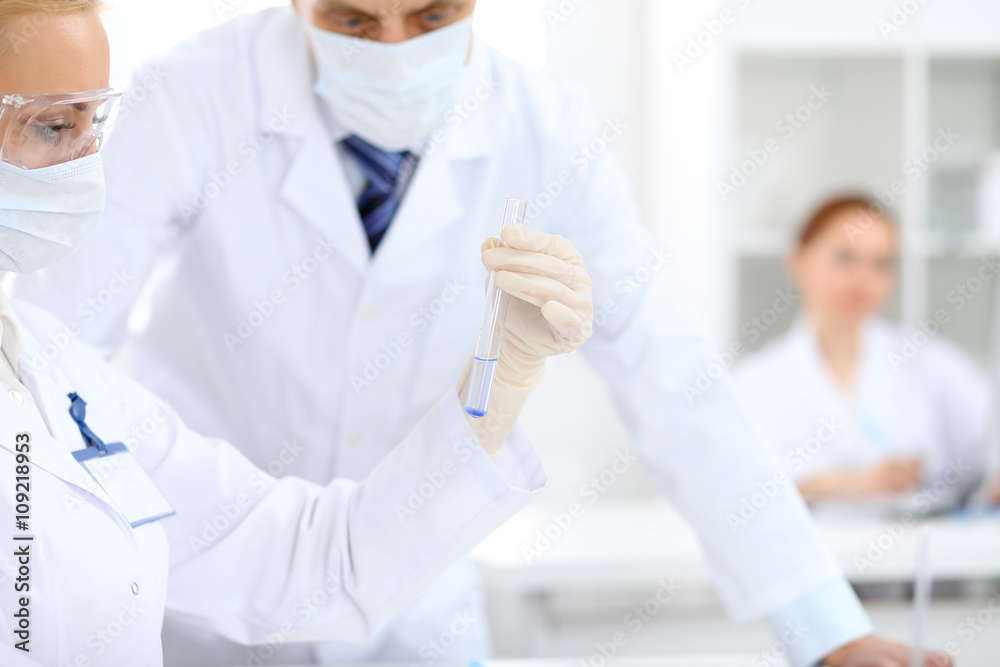 Scientific research team with clear solution in laboratory Scientific research team with clear solution in laboratory