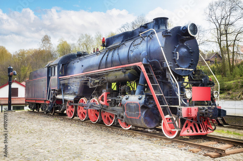 Old steam locomotive on rusty old rails