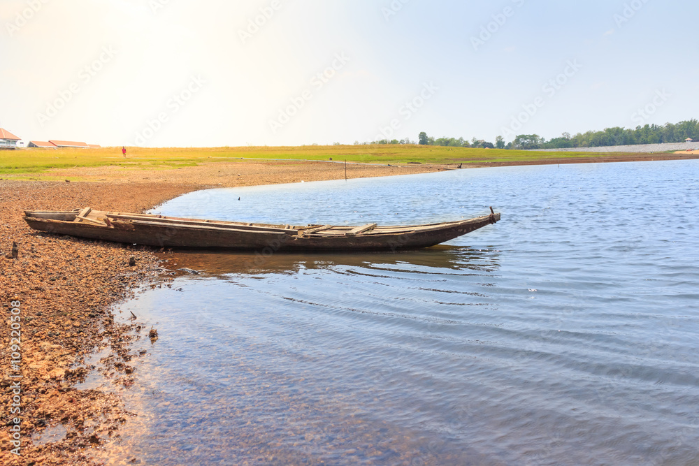 Obraz premium beautiful landscape with wooden boat on the river