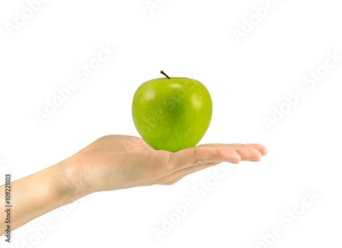 Green ripe apple in a man's hand