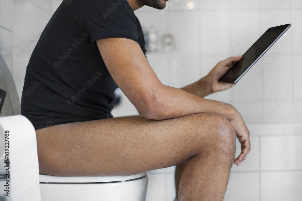 Black Man In Toilet Using Device Stock Photo Adobe Stock