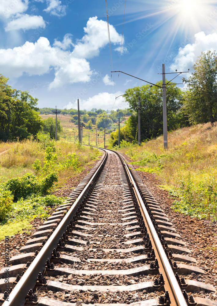 Railway passing through a beautiful landscape in the summer Railway passing through a beautiful landscape in the summer