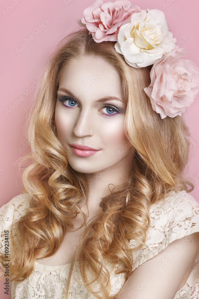 Glamour portrait of beautiful woman model with fresh daily makeup and romantic wavy hairstyle. Fashion shiny highlighter on skin, sexy gloss lips make-up and dark eyebrows on pink background.